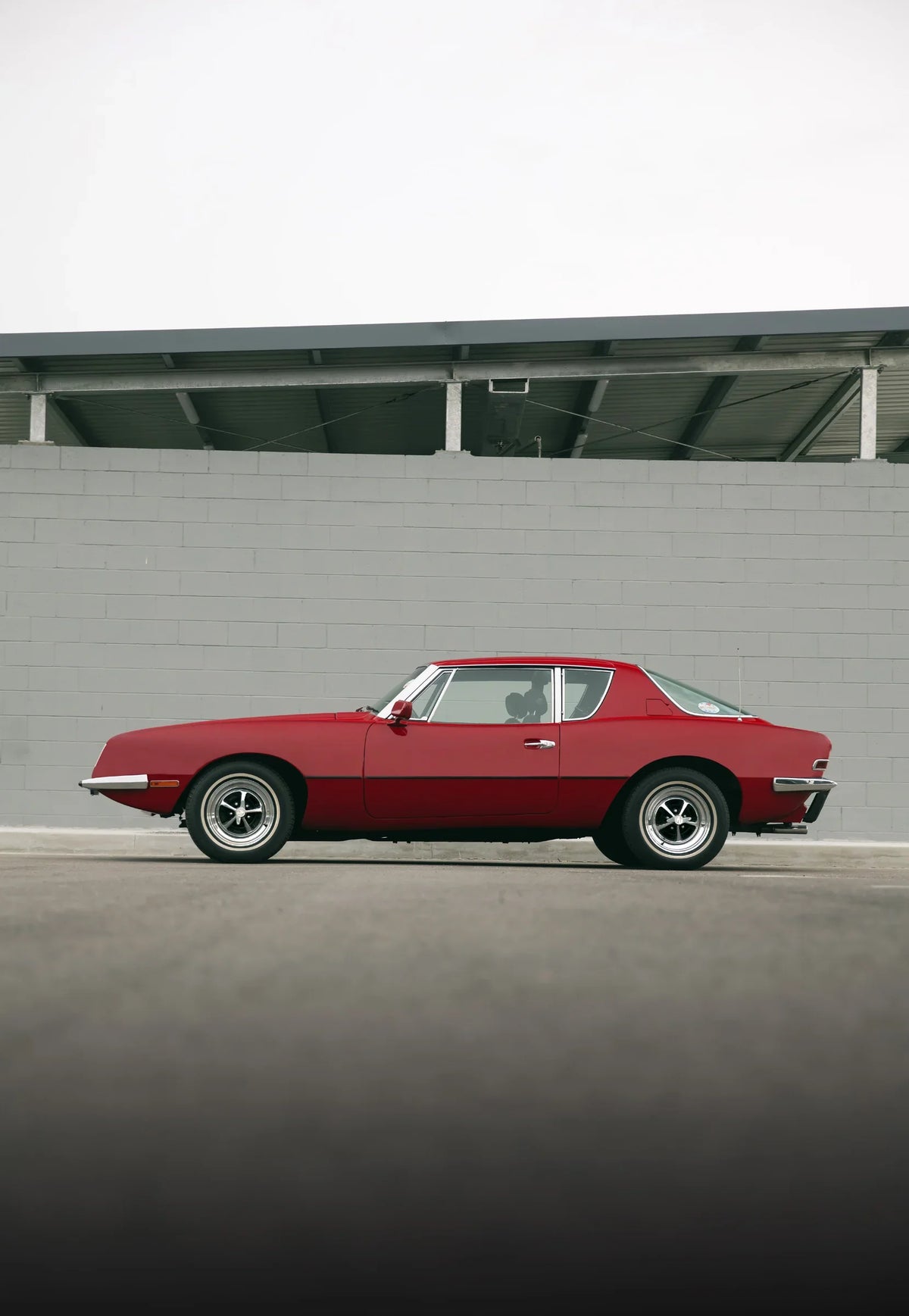 Lorna Venema’s red 1974 Avanti II in profile, photographed by Nathan Duff