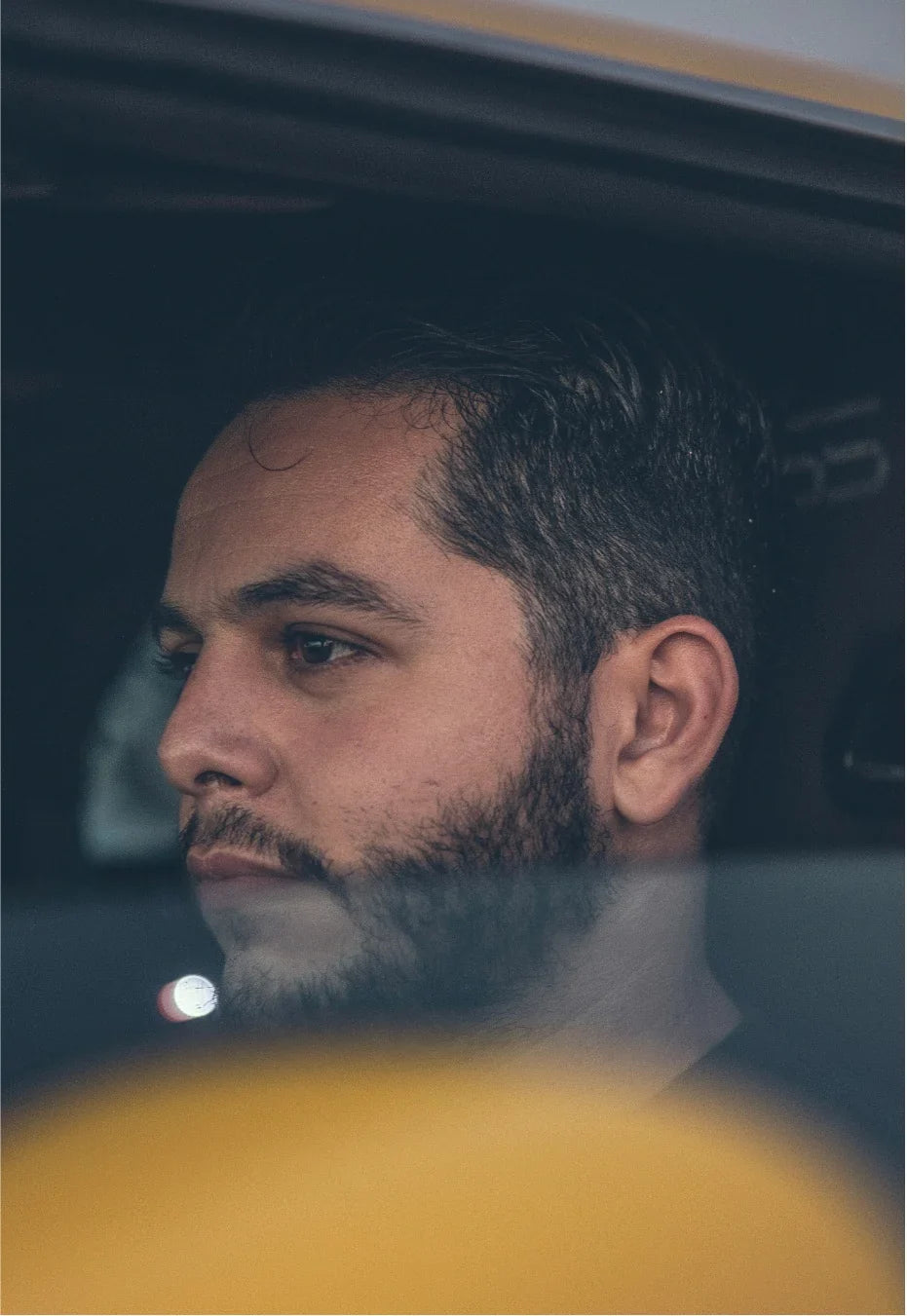 Cristian Cross photographed through a car window.