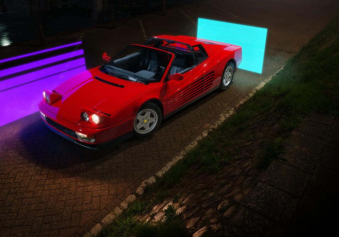 Ferrari Testarossa Targa front three-quarter view at night with raised headlights.
